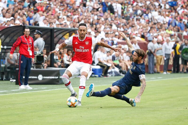 Arsenal forward Pierre-Emerick Aubameyang dribbles the ball past Real Madrid defender Sergio Ramos. Reuters