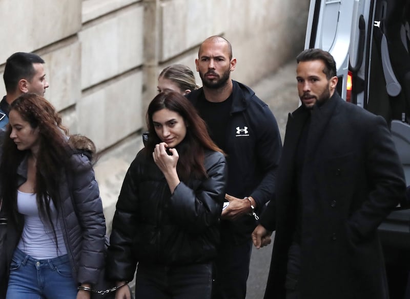 Tate, his brother Tristan and two women are escorted by officers into the Court of Appeal in Bucharest. EPA