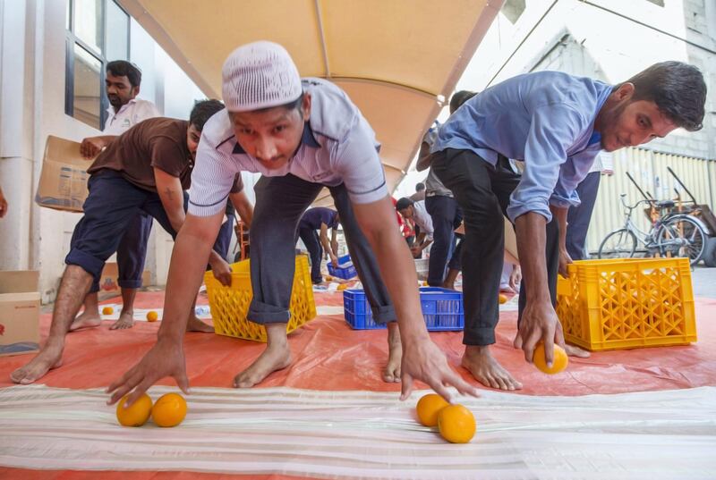 DUBAI,  UNITED ARAB EMIRATES, 20 May 2018 - Muslims are preparing the area around the mosque for the iftar at Lootah Masjid Mosque, Deira, Dubai. Leslie Pableo for The National  for Ramola Talwar story