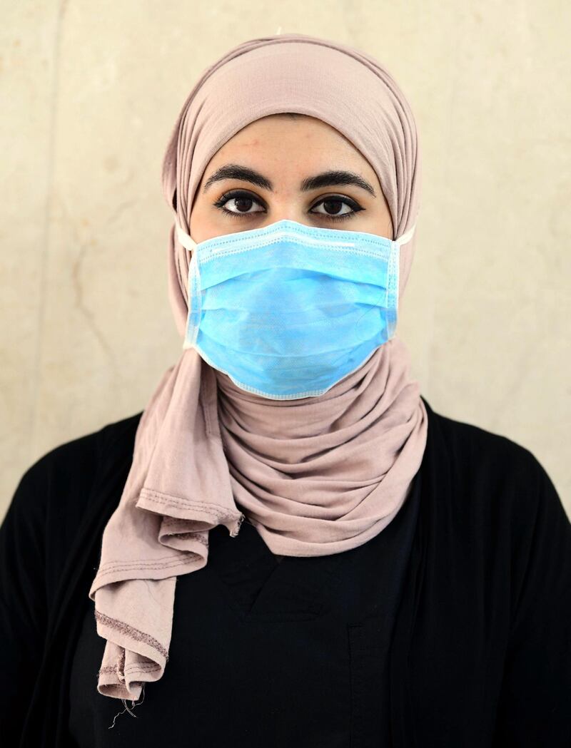 Iraqi shopkeeper Warda Salih poses for a portrait wearing a face mask in Baghdad, Iraq.  EPA