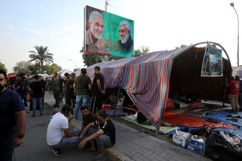 Supporters of the Al Fatih alliance take part in a protest against the result of Iraqi parliamentary elections in front of the gate of the governmental area of the green zone in central Baghdad on October 23.  EPA