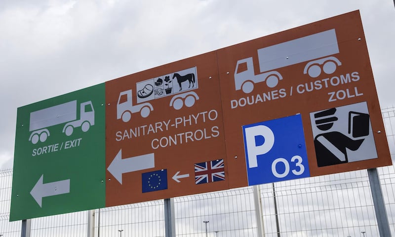A new 'orange zone' sign for U.K. livestock, food cargo and passenger customs checks with a 'green zone' traffic sign sits on display in a parking lot at the Port of Calais cross channel ferry terminal in Calais, France, on Monday, Oct. 7, 2019. The port of Calais on France’s northern coast has spent 6 million euros ($6.6 million) on facilities for customs officers, updated signage around freshly painted roads and huge extra parking lots for trucks. Photographer: Marlene Awaad/Bloomberg