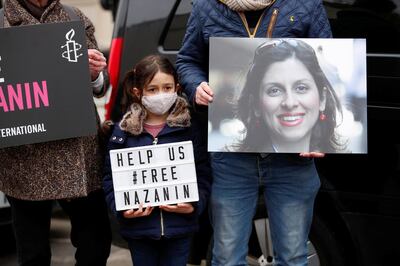 Gabriella Ratcliffe, daughter of British-Iranian aid worker Nazanin Zaghari-Ratcliffe, protests outside the Iranian Embassy in London, Britain March 8, 2021. REUTERS/Andrew Boyers