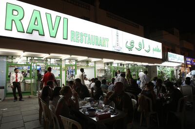 DUBAI, UNITED ARAB EMIRATES – Mar 24: People enjoying food in the evening at Ravi restaurant in Al Satwa in Dubai. (Pawan Singh / The National) For Personal Finance. Story by Daniel Bardsley  *** Local Caption ***  PS07- RAVI RESTAURANT.jpg