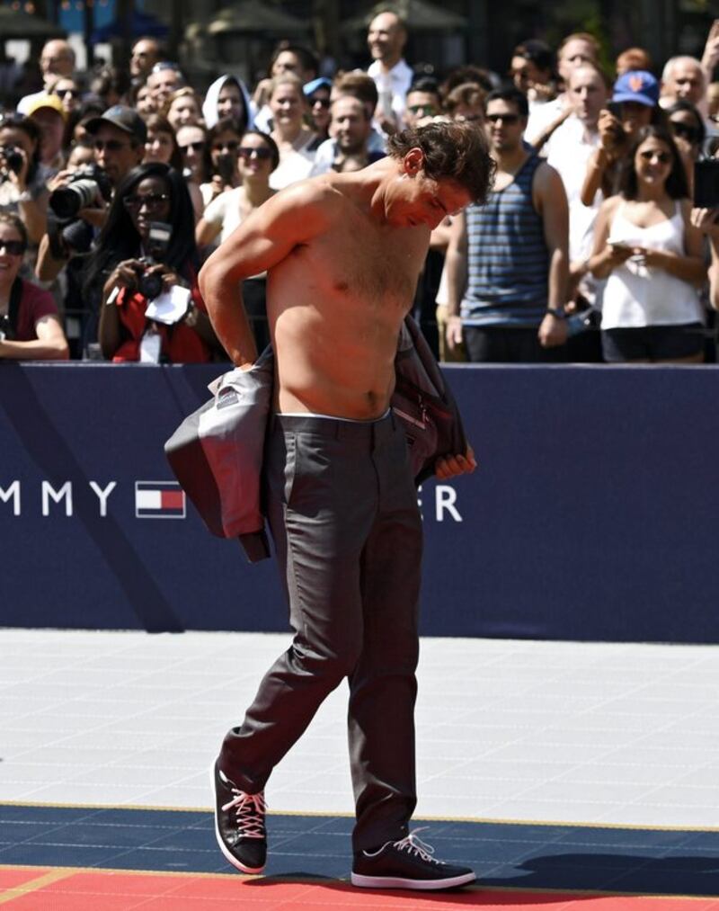 Rafael Nadal removes his jacket during an outdoor tennis exhibition in New York City on Tuesday. Justin Lane / EPA