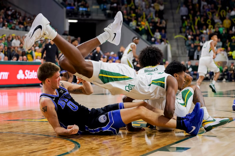 Baylor centre Yves Missi, top, is brought down by BYU forward Noah Waterman in an NCAA college basketball game in Waco, Texas. Baylor won 81-72. AP