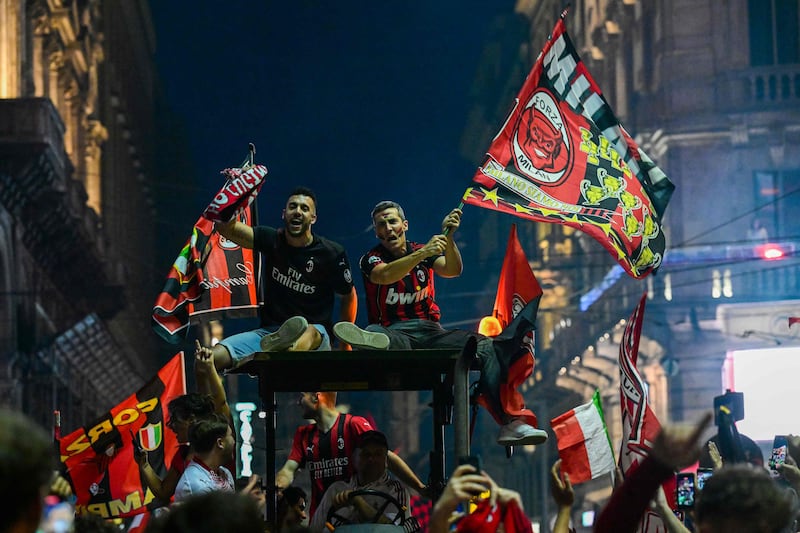 Fans celebrate on a tractor in downtown Milan after AC Milan won the Serie A title. AFP