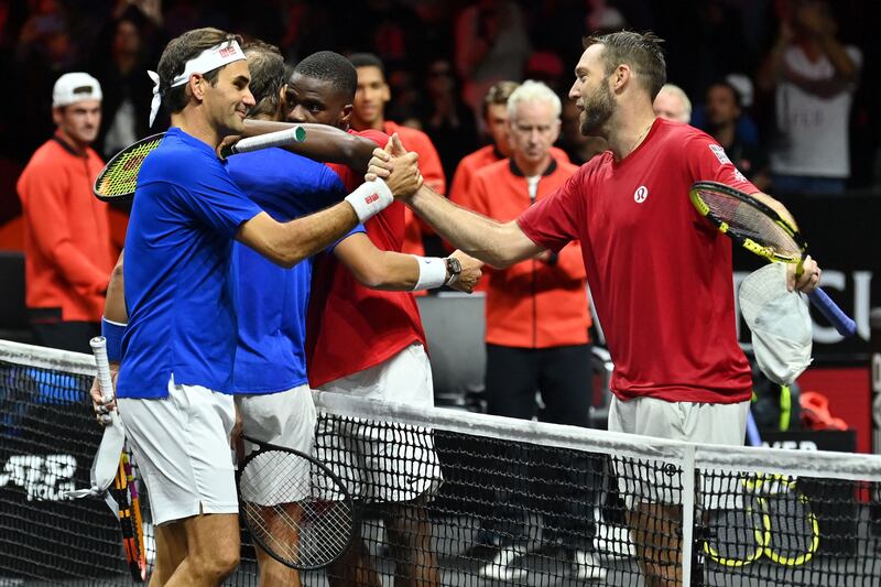 Roger Federer shakes hands with USA's Jack Sock of Team World after their Laver Cup doubles match at the O2 Arena in London. AFP