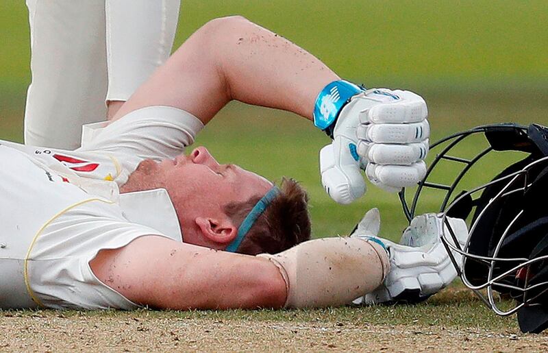 (FILES) In this file photo taken on August 17, 2019 Australia's Steve Smith lays on the pitch after being hit in the head by a ball off the bowling of England's Jofra Archer (unseen) during play on the fourth day of the second Ashes cricket Test match between England and Australia at Lord's Cricket Ground in London on August 17, 2019. Australia's star batsman Steve Smith has been ruled out of the third Ashes Test beginning on August 22, 2019, Cricket Australia announced August 20, 2019. The 30-year-old -- who has scored two centuries and 92 in his three innings in the first two Tests -- was felled by a Jofra Archer bouncer on Saturday in the first innings of the second Test at Lord's. - RESTRICTED TO EDITORIAL USE. NO ASSOCIATION WITH DIRECT COMPETITOR OF SPONSOR, PARTNER, OR SUPPLIER OF THE ECB
 / AFP / Adrian DENNIS / RESTRICTED TO EDITORIAL USE. NO ASSOCIATION WITH DIRECT COMPETITOR OF SPONSOR, PARTNER, OR SUPPLIER OF THE ECB
