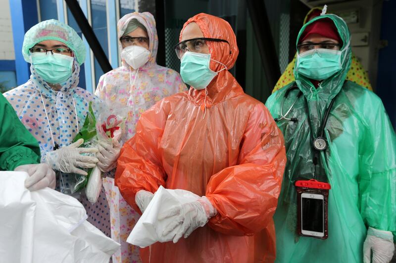 Medical workers wearing disposable raincoats as their protective suits to serve patients are pictured amid the spread of coronavirus disease outbreak at a local health centre in Aceh, Indonesia. Reuters