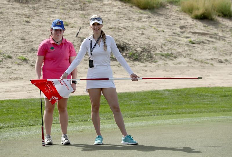 Saoirse Lambe of Ireland, who won a global competition to play with Rory McIlroy and Niall Horan is assited by Paige Spiranac during the pro-am at Emirates Golf Club. David Cannon / Getty Images