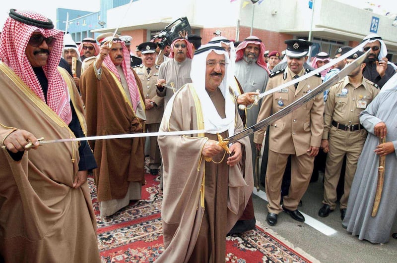 Kuwaiti Prime Minister Prince Sheikh Sabah al-Ahmad al-Sabah (C) dances a Kuwaiti traditional dance during the inauguration of the new Kuwaiti Sabah al-Ahmad al-Sabah naval base in Kuwait city 18 February 2004. The base is equipped with modern equipment and is considered one of the most modern bases in the Middle East, covering an area of 35,000 square meter.  AFP PHOTO/Yasser AL-ZYYAT (Photo by YASSER AL-ZAYYAT / AFP)