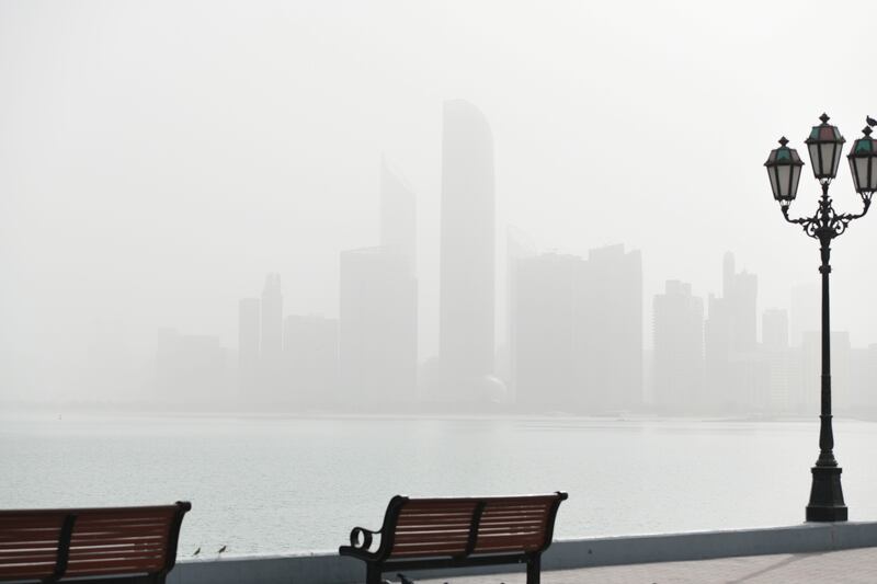 A hazy start to the day on the Corniche in Abu Dhabi. Khushnum Bhandari / The National