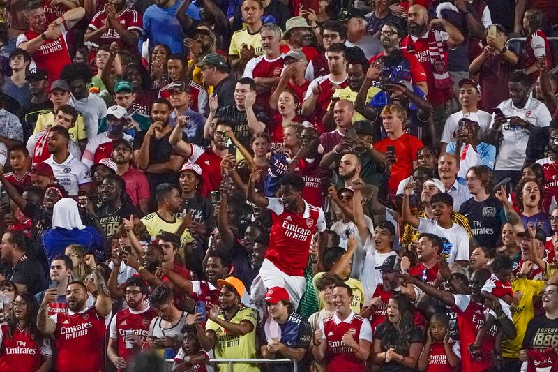 Arsenal fans celebrate after an Arsenal goal against Chelsea during the second half of the Florida Cup. AP