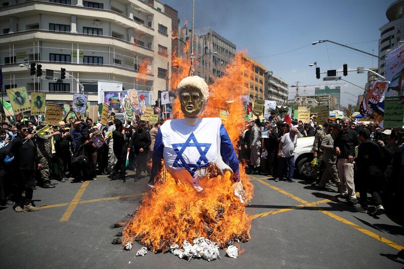 Iranians burn an effigy in the likeness of U.S. President Donald Trump during a protest marking the annual al-Quds Day (Jerusalem Day) on the last Friday of the holy month of Ramadan in Tehran, Iran June 8, 2018. Tasnim News Agency/via REUTERS  ATTENTION EDITORS - THIS PICTURE WAS PROVIDED BY A THIRD PARTY     TPX IMAGES OF THE DAY