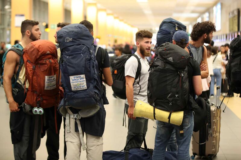 Young Israelis queue to board a flight to Tel Aviv at the Jorge Chavez International Airport in Lima, Peru, after Israel drafted more than military 300,000 reservists. EPA