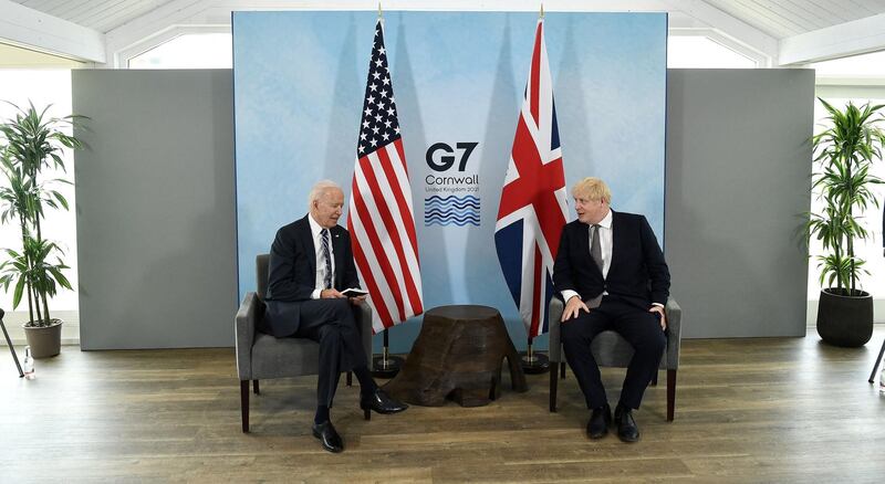 Britain's Prime Minister Boris Johnson (R) and US President Joe Biden and react during a bi-lateral meeting at Carbis Bay, Cornwall on June 10, 2021, ahead of the three-day G7 summit being held from 11-13 June.  G7 leaders from Canada, France, Germany, Italy, Japan, the UK and the United States meet this weekend for the first time in nearly two years, for the three-day talks in Carbis Bay, Cornwall. - 
 / AFP / Brendan Smialowski
