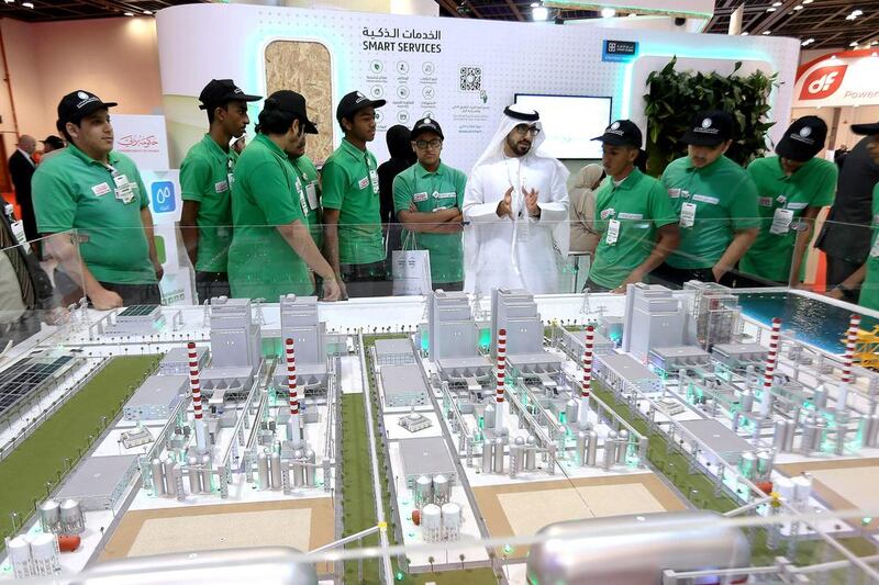Above, students at the Dewa stand during the Water, Energy, Technology and Environment Exhibition in Dubai. Pawan Singh / The National