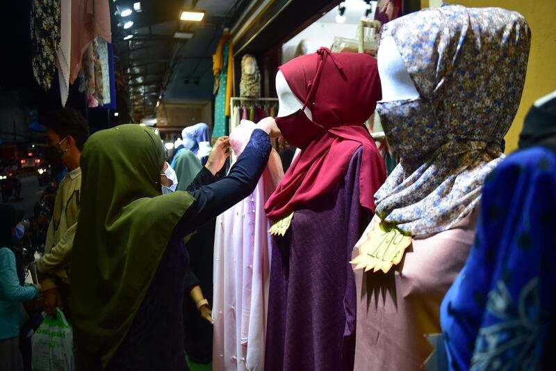 Members of the Muslim community wearing face masks amid concern over the spread of the Covid-19 shop for clothes at a market in the southern Thai province of Narathiwat, ahead of Eid Al Fitr marking the end of Ramadan.  AFP