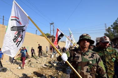 Members of Iran-backed Kataib Hezbollah (Hezbollah Brigades) carry their flag during the funeral of their leader, who was killed in a drone attack a day earlier near the Iraqi western border with Syria, 26 August 2019. EPA