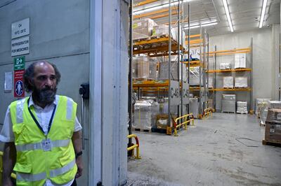 A worker stands next to packages inside a cargo centre during the tour of Beirut airport. EPA