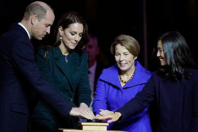 Prince William and Kate, Princess of Wales help Massachusetts Governor-elect Maura Healey, centre, and Boston Mayor Michelle Wu illuminate buildings in Boston in green. AP 