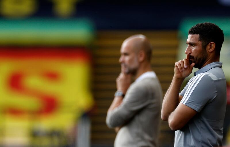 Watford's interim manager Hayden Mullins, right, and Manchester City's Pep Guardiola. AP