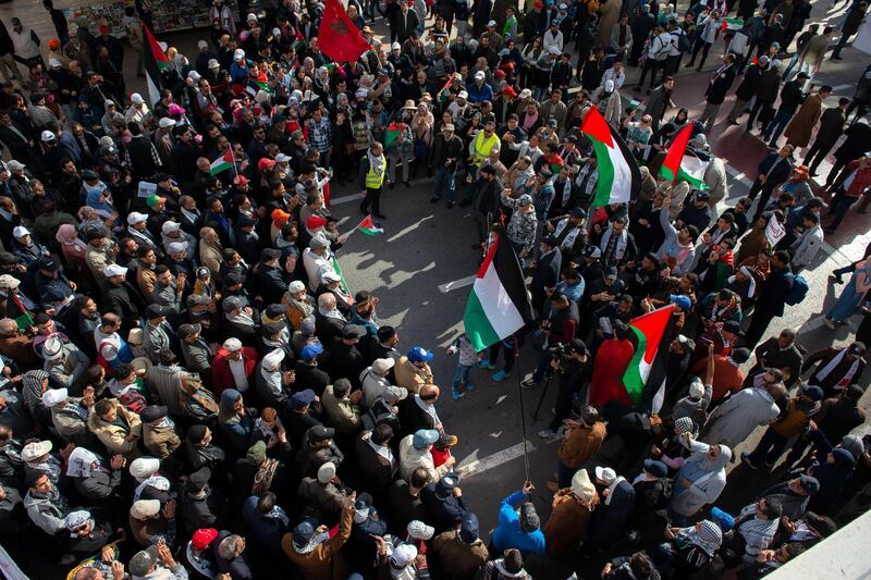 People hold Palestinian flags and shout slogans during a protest against the so-called 'Deal of the Century' in Rabat, Morocco.  EPA