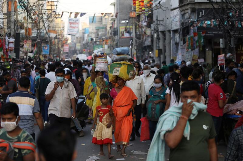 People are seen at a market amid the spread of the coronavirus, in the old quarters of Delhi. Reuters