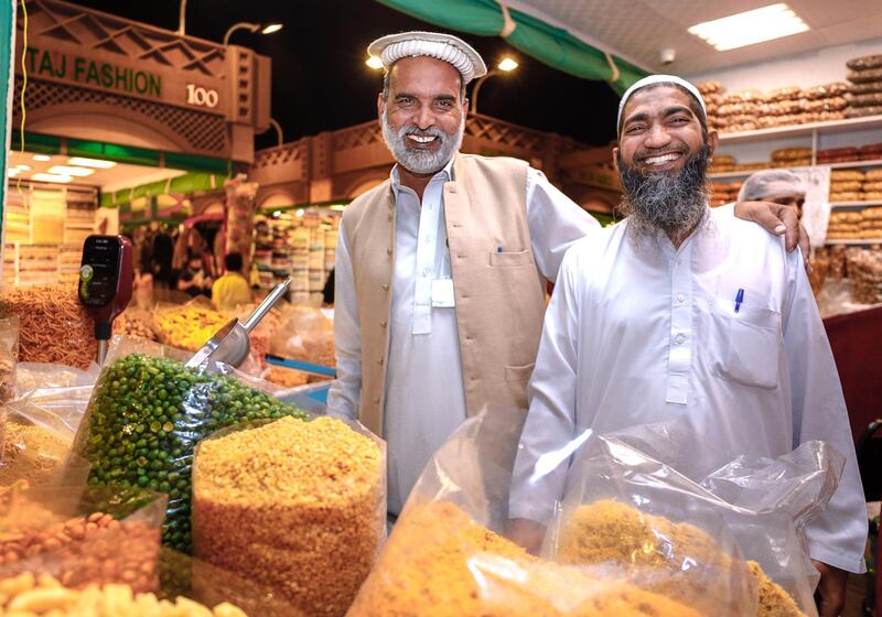 Abu Dhabi, United Arab Emirates, January 5, 2020. Photo essay of Global Village.
 -- Cousins and partners of Karachi Nimko, a snack stall which sells peanuts, peas and other finger snacks. Both from Islamabad, Pakistan.
Malik Abdul Rehman, 49, right,  and Mohammad Bashir, 50.  They have been operating the shop for eight years now.
Victor Besa / The National
Section:  WK
Reporter:  Katy Gillett