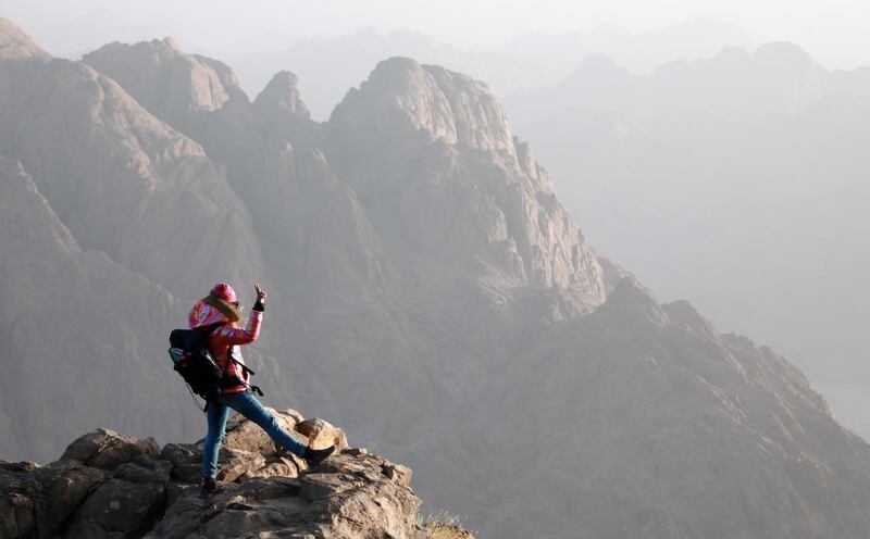 A tourist watches the sunrise outside a church on the top of Mount Moses, in Saint Catherine city, South Sinai, Egypt. EPA