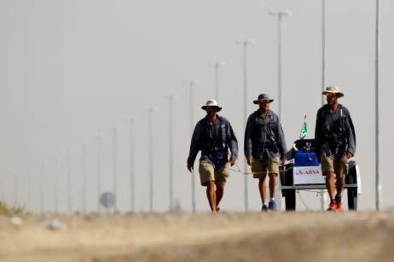 (From left) David Joyce, Marco Broccardo and Alex Harris trek southeast of Dubai on their way to setting a world record by being the first men to cross the Empty Quarter unsupported. Christopher Pike / The National