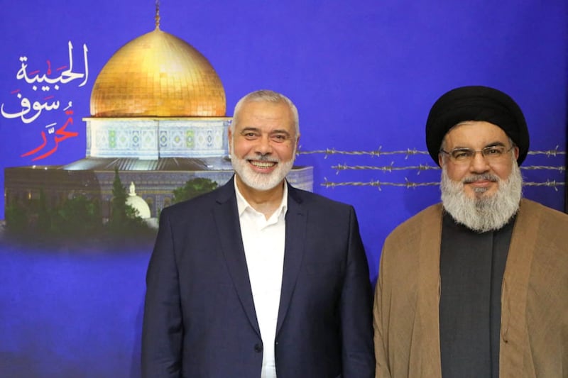 Hassan Nasrallah, head of Lebanon's Iran-backed Hezbollah, right, poses for a picture with Hamas leader Ismail Haniyeh following a meeting at an undisclosed location. AFP