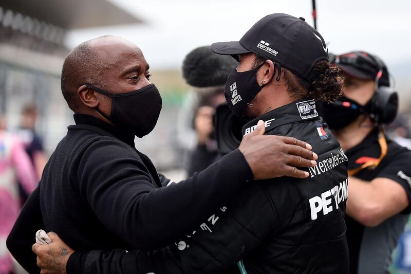 Lewis Hamilton celebrates victory with his father Anthony. AFP