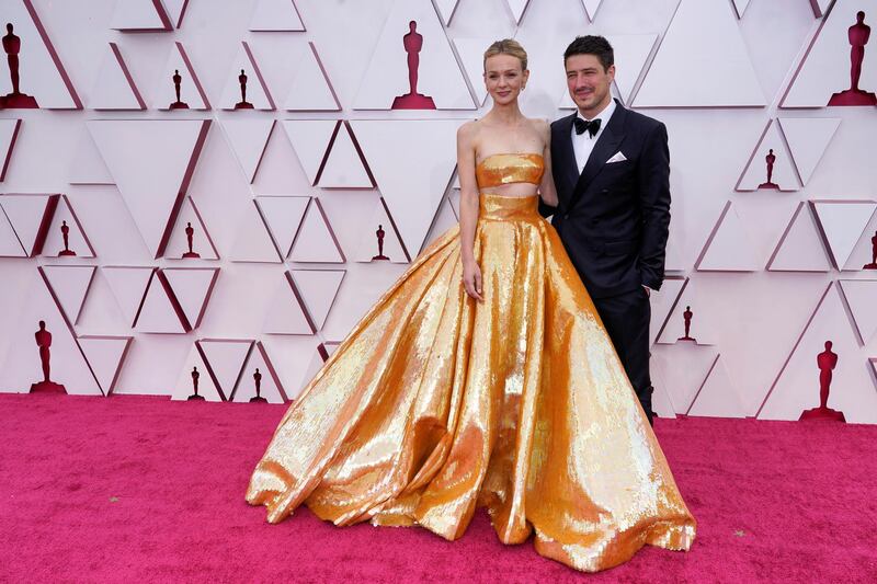 Carey Mulligan, left, and Marcus Mumford arrive to the Oscars red carpet for the 93rd Academy Awards in Los Angeles, California, US, April 25, 2021. Reuters