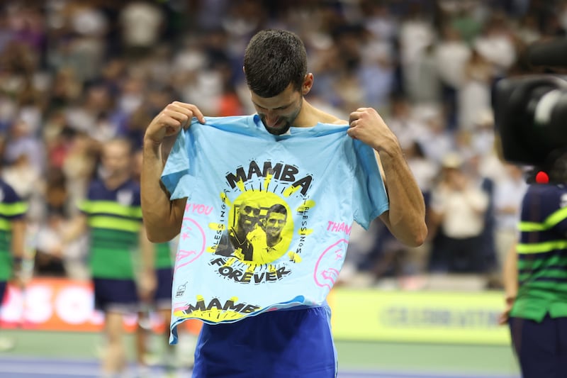 Novak Djokovic displays his 'Mamba Forever' t-shirt to the crowd after winning the US Open final. EPA