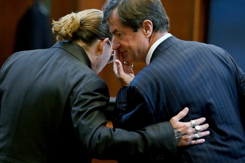 Johnny Depp speaks to his lawyer, Ben Chew, during the trial. AP