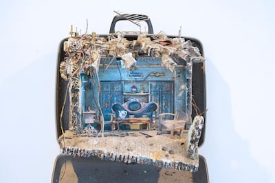Mohamad Hafez creates minute, dollhouse-like scenes within old and antique suitcases, referencing the conditions of war and exile that he and his fellow Syrians have lived through. Courtesy Middle East Institute