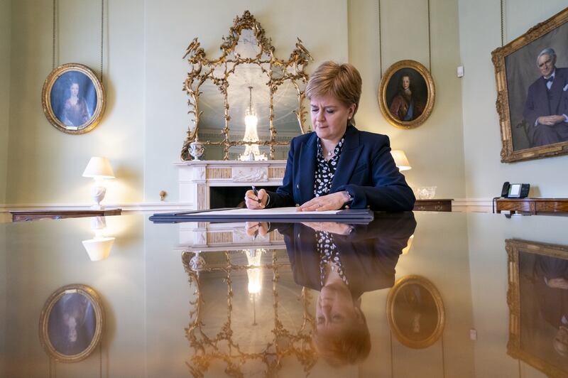 Outgoing First Minister of Scotland Nicola Sturgeon signed her official resignation letter to King Charles III in the Drawing Room at Bute House in Edinburgh on Tuesday. PA