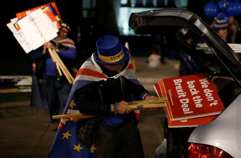 Anti-Brexit protester Steve Bray packs away placards into his car after the result was announced on Prime Minister Theresa May's Brexit deal, outside the Houses of Parliament in London, Britain, January 15, 2019. REUTERS/Henry Nicholls