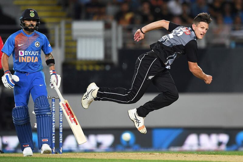 New Zealand's Hamish Bennett bowls as Virat Kohli looks on in Auckland on Friday. AP