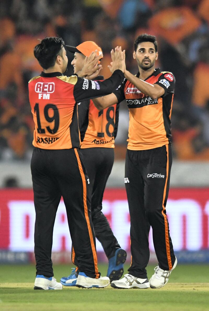 Sunrisers Hyderabad cricketer Bhuvneshwar Kumar (R) celebrates with his teammates for the wicket of Delhi Capitals batsman Shreyas Iyer (unseen) during the 2019 Indian Premier League (IPL) Twenty20 cricket match between Sunrisers Hyderabad and Delhi Capitals at the Rajiv Gandhi International Cricket Stadium in Hyderabad on April 14, 2019. (Photo by NOAH SEELAM / AFP) / ----IMAGE RESTRICTED TO EDITORIAL USE - STRICTLY NO COMMERCIAL USE-----