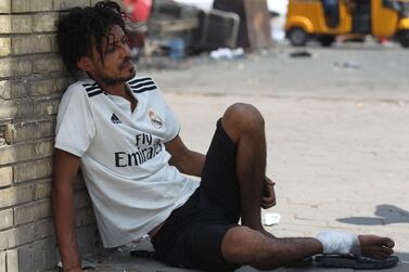 An Iraqi protester wounded in confrontations with security forces attempts to rest in Baghdad's Tahrir square. AFP