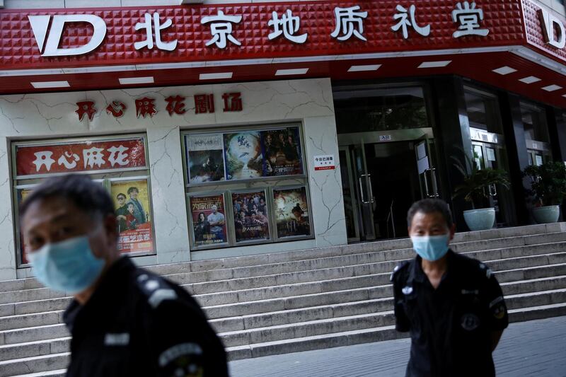 Security guards patrol outside the Dizhi Hall cinema, which was also closed. Reuters