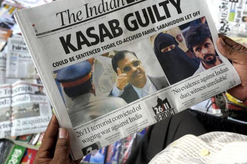 An Indian man reads a newspaper carrying a front-page story of convicted 2008 Mumbai attacks gunman Mohammed Ajmal Amir Kasab in Kolkata on May 4, 2010. An Indian judge weighed whether to send the lone surviving gunman from the 2008 Mumbai attacks to the gallows after his conviction for murder and waging war against India during the deadly siege. The prosecution is seeking the death penalty against Mohammed Ajmal Amir Kasab, a 22-year-old Pakistani, who was found guilty on May 3 after a year-long trial in a high-security prison. AFP PHOTO/Deshakalyan CHOWDHURY *** Local Caption ***  442275-01-08.jpg