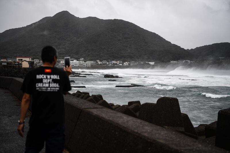 A man takes pictures as he walks along the coast as Typhoon Haishen approaches in Makurazaki, Kagoshima prefecture.  AFP