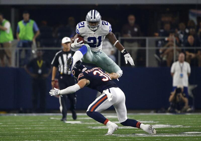 Dallas Cowboys running back Ezekiel Elliott, number 21, leaps over a tackle attempt by Chicago Bears’ Chris Prosinski, number 31, in the second half of an NFL football game, in Arlington, Texas. Ron Jenkins / AP Photo