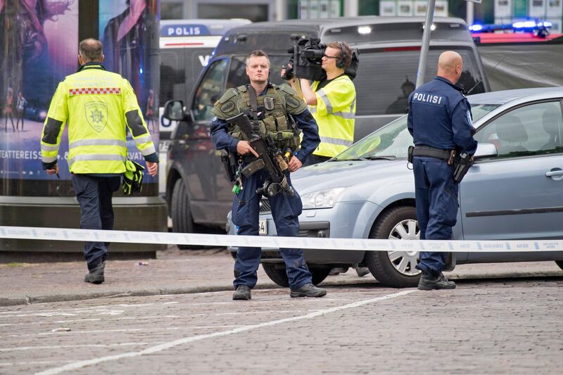 Police officers gather at the site of a multiple stabbing in Turku, Finland.  EPA.