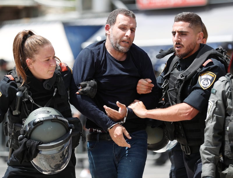 Israeli forces arrest a Palestinian protester in Jerusalem during the flag march. EPA