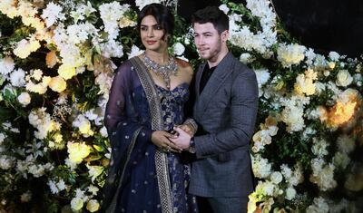 epa07240380 Newlyweds, Bollywood actress Priyanka Chopra (L) and US musician Nick Jonas (R) pose for photographs during a reception in Mumbai, India, 19 December 2018.  EPA/DIVYAKANT SOLANKI